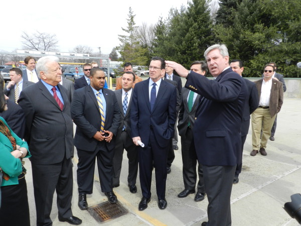 Gov. Dannel P. Malloy, center, surveys the site of a solar panel system at 542 Westport Ave. in Norwalk that will be financed through the state's C-PACE program. 