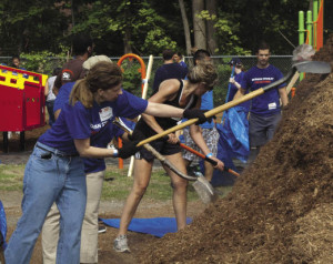 Volunteers from Morgan Stanley collaborate with White Plains residents to build the main play set on Rochambeau”™s school grounds.