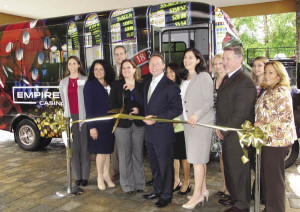 From left: Marissa Quattrone, Empire City Casino; Catherine Stevens, Renaissance Westchester Hotel; Taryn Duffy, Empire City Casino; Westchester County Executive Robert P. Astorino; Natasha Caputo, Director of Westchester County Tourism and Film; David Leftwich, IBM Learning Center; and representatives from participating hotel partners launch the debut of the Empire City Casino shuttle bus at a ribbon cutting ceremony outside the Renaissance Westchester Hotel.