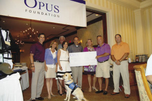 Pictured from left, Russ Carpentieri, Opus Advisory Group managing partner; Susan Dishart, executive director, Guiding Eyes for the Blind; Michael Perry, managing partner, Opus Advisory Group; Judith Factor, executive director, Friends of Karen; Martin Gorman, executive director, Children”™s Health and Research Foundation; Ellen Lynch, executive director, Food Bank for Westchester; Nick Palumbo, managing partner, Opus Advisory Group; Scott Tasch, director, Opus Advisory Group; and Sophie, Guiding Eyes Heeling Autism.