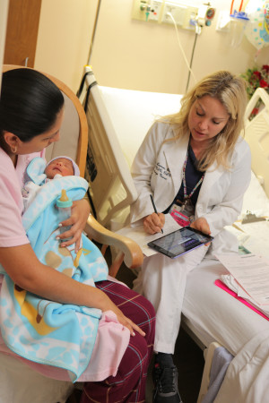 White Plains Hospital nurse Laurie Larraz assists in discharging a mother and her baby.