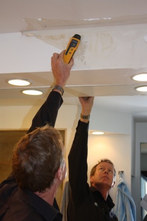 The device Robert Weitz is holding reads through the wall to let him know if there is dampness.