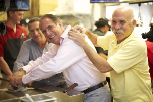 Smash Partners Ronnie Portnoy, Richard Greenstein and Howard Novick smash a burger together on the 400-degree flat grill in their newest Smashburger restaurant.