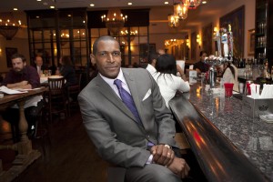 Alvin Clayton in his restaurant that uses energy efficient lighting.