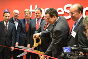 Gov. Dannel P. Malloy, right, cuts the ribbon on HomeServe”™s new headquarters with other government and company officials.