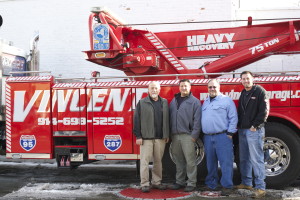 Vincent's 65-ton tow truck can lift up to 75 tons. Left to right, Michael Lungariello, Matthew Lungariello, Anthony Paniccia and Anthony Paniccia Jr.
