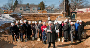 Government, business and health care officials join David Bigley, foreground, son of landlord principals John and Eleanor Bigley, at the groundbreaking.