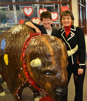 Executives Brigid Smith and Cecilia McKenney with Frontier Communication”™s mascot Frank the buffalo.