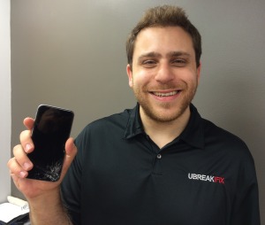 Jesse Glassberg of uBreakiFix holds a broken iPhone 6. Photo by Leif Skodnick