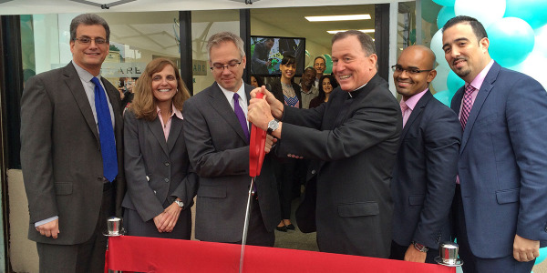 Joining in the ribbon-cutting at Fidelis Care's Yonkers office were, from left, Mark Sclafani, Fidelis vice president of marketing; Pamela Hassen, chief marketing officer;  David Thomas, executive vice president and chief operating officer; the Rev. Patrick J. Frawley, president and CEO; Joenny De Los Santos, marketing manager; and George Rodriguez, marketing director.  