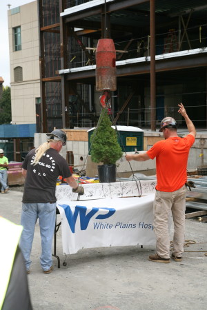 Ironworkers hoist the last  steel beam on a 52,000-square-foot addition at White Plains Hospital. 