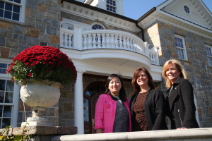 Houlihan Lawrence Realtors, from left, Tianying Xu, Elizabeth Nunan and Lesli Hammerschmidt outside a Chappaqua home listed for sale at nearly $6.5 million. Photo by John Golden