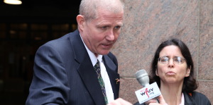 Jim Killoran, executive director of Habitat for Humanity of Westchester, speaks to reporters in front of Grand Central Terminal, while Graciela Heymann of The Westchester Hispanic Coalition looks on. Photo by Mark Lungariello