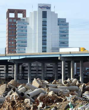 Piles of dirt and debris cover Steel Point in Bridgeport, with Interstate 95 and downtown in the background. Photo by Ned Gerard