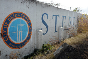 The Steelpointe Harbor logo has been visible for years on a wall that remains from an old industrial structure at Steel Point in Bridgeport. Photo by Ned Gerard