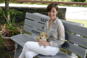 Holly Alexander”™s new SavAdate company will help nonprofits such as Adopt-A-Dog in Armonk, where Alexander is pictured with rescue dog Spike. Photo by Bob Rozycki