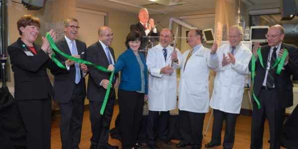 Joining in a recent ribbon-cutting for the new surgical center at Phelps Memorial Hospital Center were, from left, Mary McDermott, vice president, nursing services; Richard Sinni, board chairman; Daniel Blum, president; Kathleen Scherf, nursing director, surgical services; Dr. Avraham Merav, medical director for surgical services, holding ceremonial scalpel with Dr. Richard Peress, surgery department director; Dr. Lawrence Faltz, chief medical officer; Kerry Pisano, vice president, support services; and in rear, Robert Lane, vice president for development. 