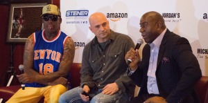 Former NBA star Dennis Rodman and WFAN radio host Craig Carton look on as Magic Johnson describes his participation in the 1992 NBA All-Star game.