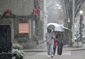 Pedestrians during a recent snowstorm in downtown Danbury. The city's mayor is proposing to offer free Wi-Fi downtown and in other business corridors. Photo by H John Voorhees III