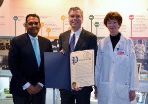 White Plains Mayor Thomas Roach, center, and Burke Rehabilitation Hospital Executive Medical Director Dr. Mary Beth Walsh and Dr. Rajiv Ratan pose for a photo with a proclamation from the city of White Plains celebrating the hospital”™s 100th anniversary.