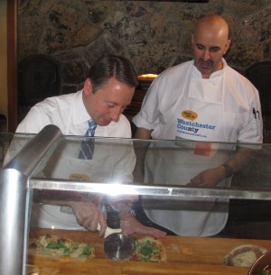 Westchester County Executive Robert P. Astorino prepares pear and blue cheese pizza with David Amorelli, Harvest on Hudson executive chef.