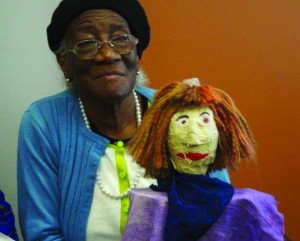 Urany Sharpe displays her puppet creation.