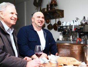 Chef and owner Joseph D”™Angelo, right, stands at the bar with a guest.