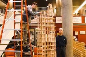 Professor Michael Cavanaugh, right, beside a tower of Keva planks.