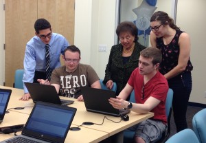 Students show U.S. Rep. Nita Lowey their laptops in the STEM Research Lab at Mercy College. Photo by Danielle Brody