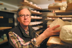 Cheese maker Alan Glustoff in his creamery aging room. Photo by John Golden