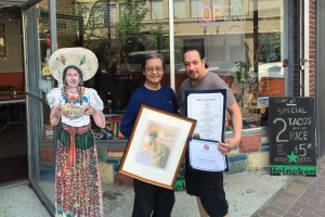 Galdino Velasco and his son John display Galdino”™s “Land of Opportunity” award, presented to him by Neighbors Link of Stamford for his civic involvement and accomplishment of running Stamford”™s first Mexican restaurant, Tacos Guadalajara, for more than 35 years.