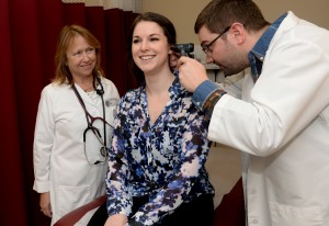 Sacred Heart University nursing professor Constance Glenn with family nurse practitioner student Ed Wirkowski, who examines fellow classmate Rachel Schiffres. Photo by Tracy Deer-Mirek