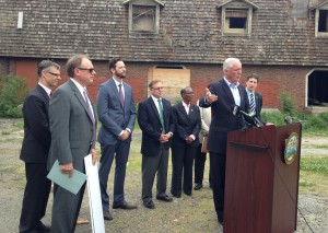 Bridgeport Mayor Bill Finch and redevelopment officials in front of a blighted Bridgeport property, the former AGI Rubber Co. building. Photo by Danielle Brody