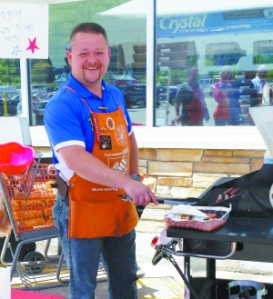 Patrick Carroll, merchandising manager of The Home Depot in Fishkill, roasts hot dogs for customers on special holidays in appreciation of their patronage.