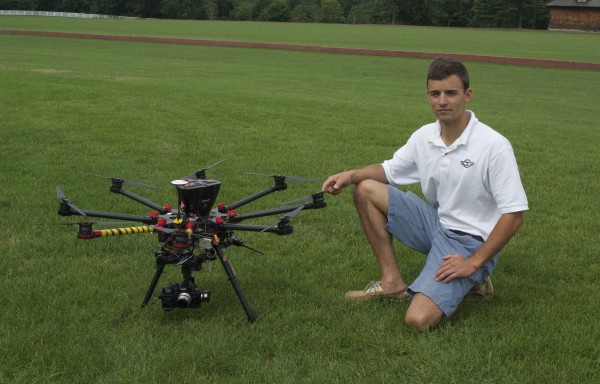 William Granruth next to one of his company”™s drones at Greenwich Polo Club, which he uses to take aerial shots of real estate in Fairfield County. Photo by Danielle Brody