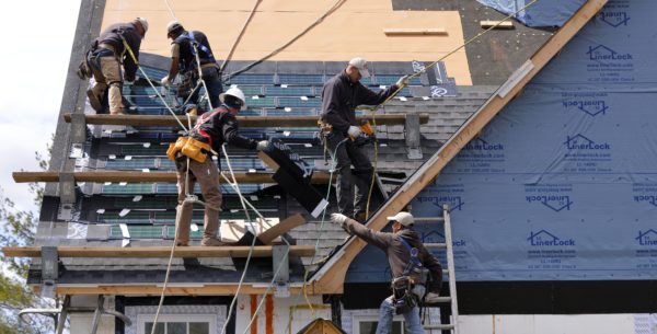 A Murphy Brothers crew installs solar shingles. Photo by Peter Krupenye