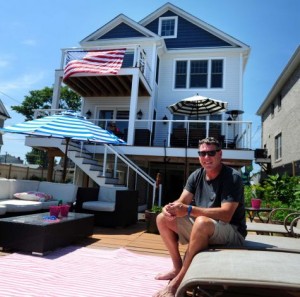 John McNamara sits in front of his home, built by Bethel-based Westchester Modular Homes of Fairfield County, in Fairfield. Photo by Autumn Driscoll