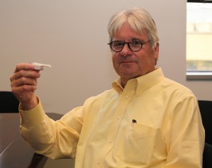 Halkan Edstrom holds a device used to deliver Afrezza in his Danbury office. Photo by Danielle Brody