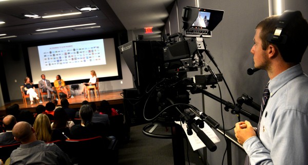 Master”™s degree student Sean Elliott films a panel discussion in June in the Martire Business and Communications Center at Sacred Heart University. Photo by Tracy Deer-Mirek