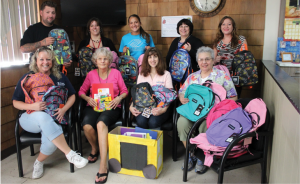 Front row, from left: Jennifer Sneider, owner, J Cuts; Marcia Jones, BHcare; Nicole Polifka, Bright Horizons Day Care; and Phyllis Hyde, Barb”™s Corner Consignment. Back row, from left: Ross James, barber, J Cuts; Jennifer Olson, principal, Irving School; Jen Deleon, Boys & Girls Club of the Lower Naugatuck Valley; Suzanne Reilly, director, Family Support Services, TEAM Inc.; and Jessica Lanzi, Lower Naugatuck Valley Parent Child Resource Center. Missing from picture: Jane Bailey, Shelton School Readiness Council. 