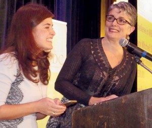 Paola Hernandez, left, texts a pledge to WBDC finance efforts with Fran Pastore, WBDC president, CEO and founder. Photo by Bill Fallon