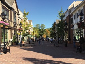 Shoppers on Armonk Square”™s pedestrian walkway on Columbus Day. Opened in 2013, the mixed-use development now has more than a dozen stores and restaurants. Photo by Evan Fallor 