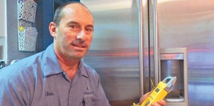 Preparing for repair on a refrigerator, Christopher Lombardi is owner of Absolute Repair Inc. of Putnam Valley.