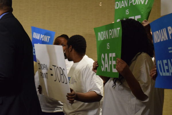 Union members hold signs in support of Indian Point at a press conference before the annual NRC hearing in Tarrytown.