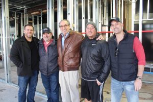 Don Myers, David Nevins, Brad Nevins, Doug Nevins and Jeremy Nevins stand in the space that will soon house Siegel Bros. Marketplace.