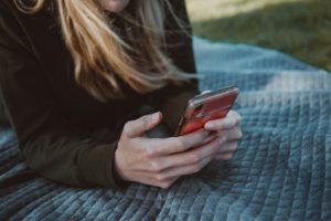 Woman reading text on mobile phone