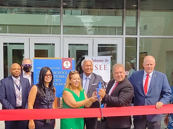 Yonkers Mayor Mike Spano, second from right, at the charter high school ribbon-cutting on Sept. 15. Eduardo LaGuerre stands behind the scissors.