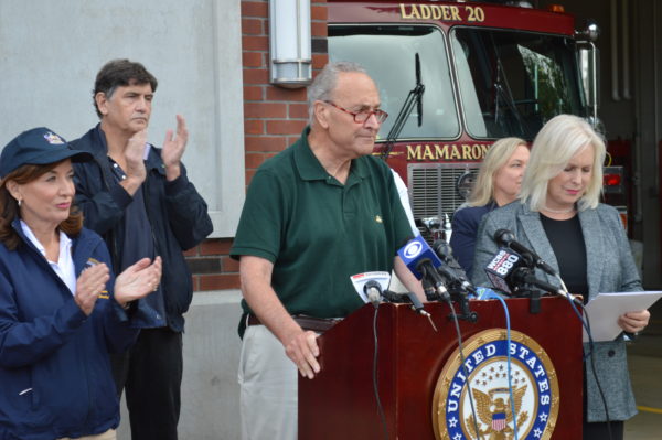 Schumer speaks in Mamaroneck on Sept. 3 after the flooding with Gov, Kathy Hochul, left, and Sen. Kirsten Gillibrand, right. Photo by Peter Katz.