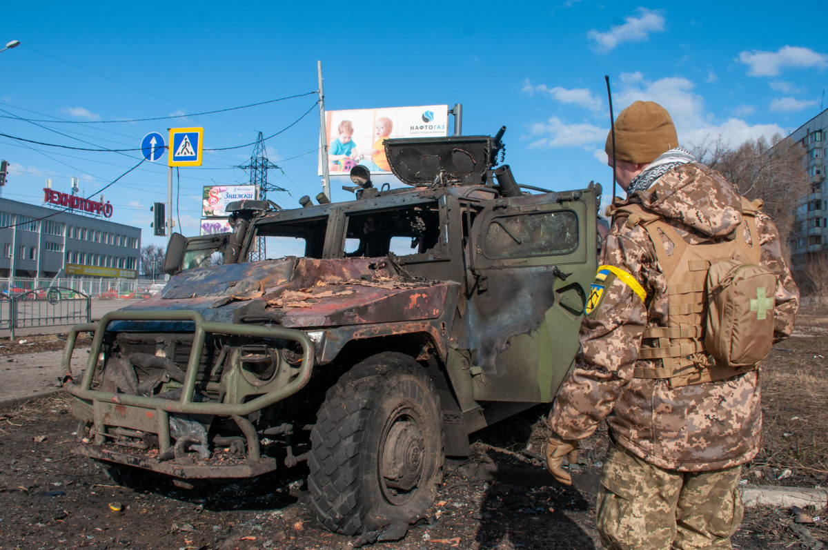 Ukrainian soldier at burned-out Russian vehicle in Kharkov.