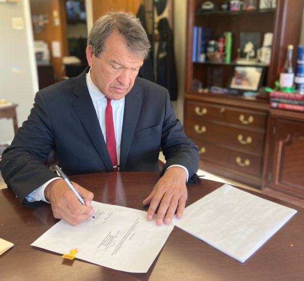 County Executive George Latimer signs gas tax cap into law.